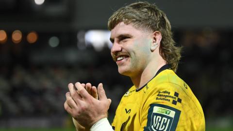 Aaron Wainwright applauds the Dragons fans after victory