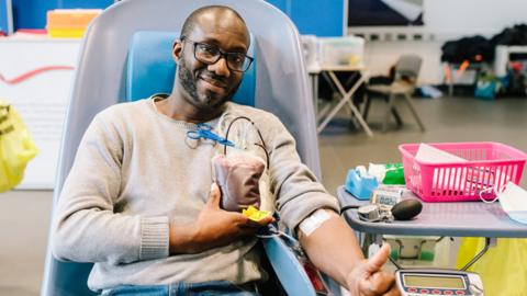A man donating blood at a session in Croydon, south London