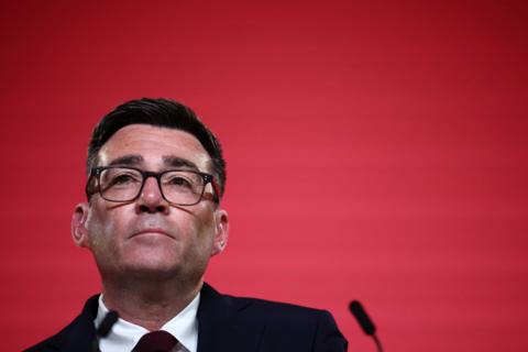 Andy Burnham against a red background