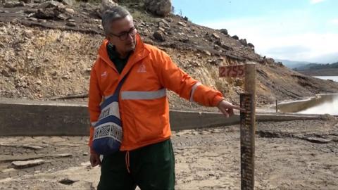 Bogota Aqueduct employee checks water levels