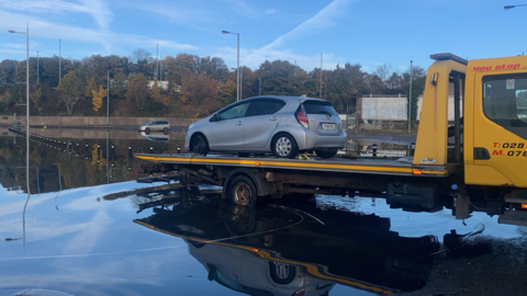 Car on back of vehicle at Portadown train station car park
