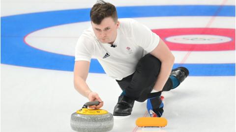 Team GB curler Bruce Mouat plays a shot against Sweden the 2022 Winter Olympics