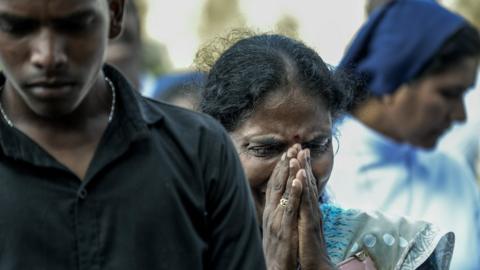 Relatives cry at the graveside during the funeral of a victim of the Easter Sunday Bombings at a local cemetery on April 24, 2019 in Colombo,