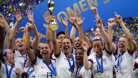 The US women's national team lifting the World Cup in 2019