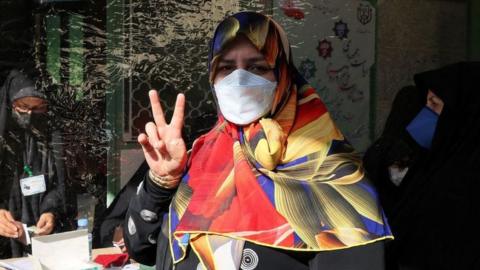 A woman votes in Teheran in the Iranian presidential election, 18 June 2021