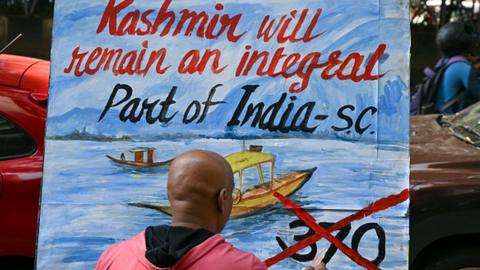 An art school teacher makes a painting depicting the Supreme Court's verdict on Article 370, in Mumbai on December 11, 202