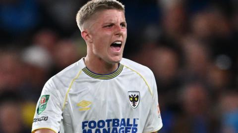 Morgan Williams in action for AFC Wimbledon against Chelsea in August 2023
