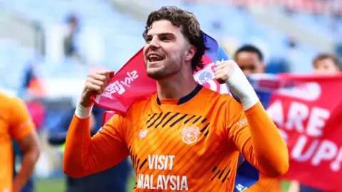 Cardiff City players celebrate after securing promotion to the Championship