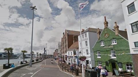 Poole Quay with the harbour on the left and historical buildings on the right