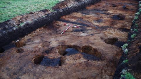 An Iron Age roundhouse during excavation.