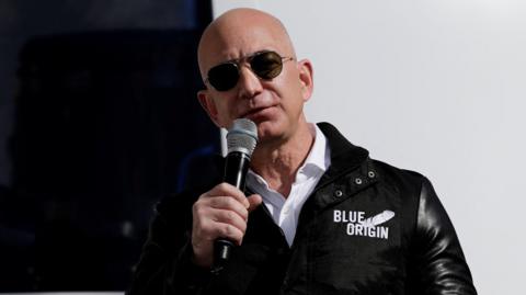 Amazon and Blue Origin owner Jeff Bezos speaking at a launch site. 