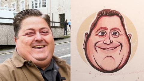 Artist Adam Brown smiles at the caricature he drew of himself