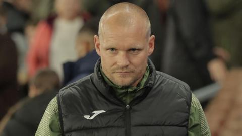 Norwich City boss Liam Manning looking pensive