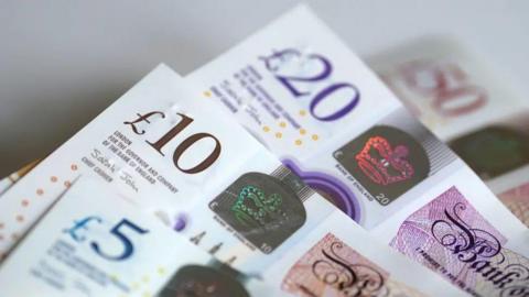 A photo of British £5, £10 and £20 notes