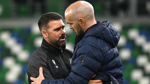 Linfield and Shelbourne's managers embracing after the game at Windsor Park