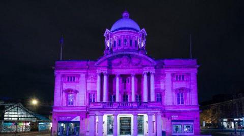 Hull City Hall lit up in purple at night