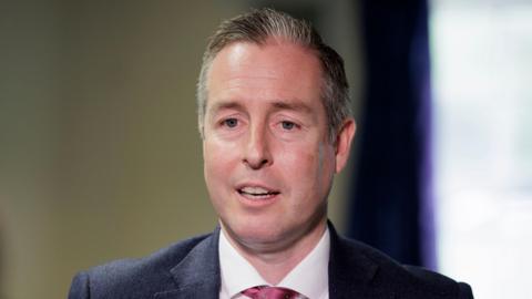 Headshot of Paul Givan wearing a suit and tie. 