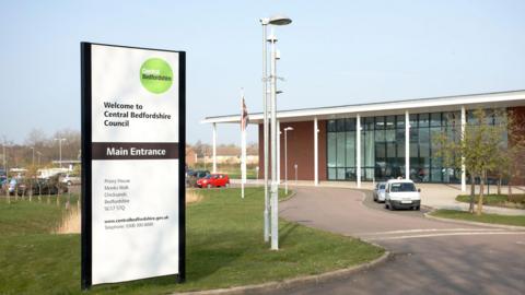 A picture of Central Bedfordshire Council's Headquarters at Chicksands. It should the building with a sign welcoming people to Central Bedfordshire Council.