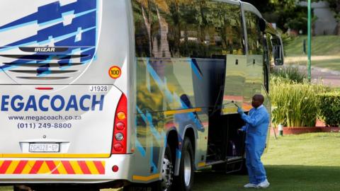A forensic investigator searches for clues on a bus alleged to have been used by the 36 Dutch tourists who were robbed at gunpoint on Sunday in a brazen heist while traveling from Johannesburg's main international airport to their hotel, officials said