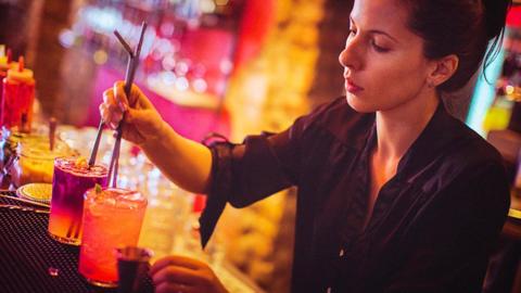 Stock image of a woman making drinks in a bar