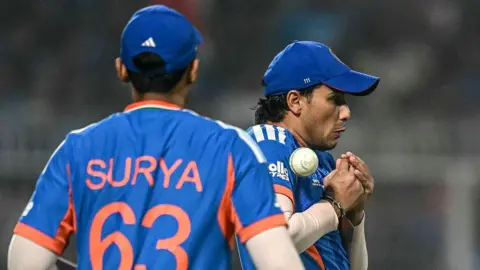 India's Abhishek Sharma (R) drops a catch of West Indies' Roston Chase as his captain Suryakumar Yadav watches during the 2026 ICC Men's T20 Cricket World Cup Super Eights match between India and West Indies at the Eden Gardens