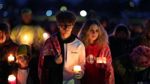 Community members gather in Wiese park for a candlelight vigil following the morning shooting at the Perry Middle School and High School complex on January 04, 2024 in Perry, Iowa.