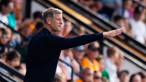 Newport County manager Dave Hughes gives instructions from the touchline