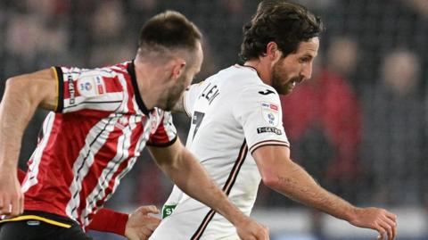 Swansea City midfielder Joe Allen runs with the ball against Sheffield United