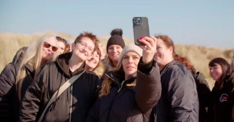 A group of people taking a selfie outside