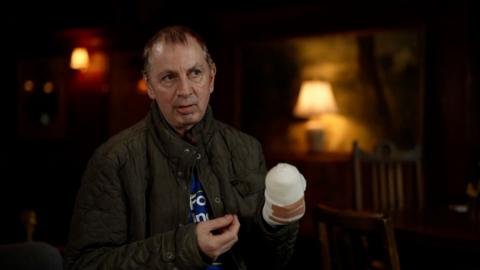 Stephen Crean speaks to the BBC during sit-down interview, his hand seen bandaged