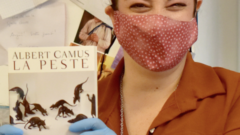 A bookseller with a copy of The Plague (La Peste) in Italy