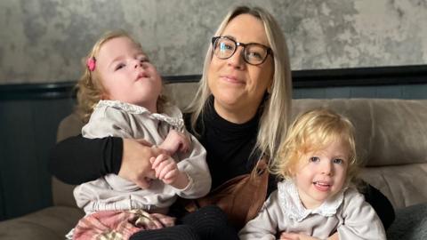 Sam Crawford, centre, with her daughters. Ava is on the left and Olivia on the right