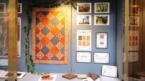 Items are on a table in the foreground and other items are on the wall.