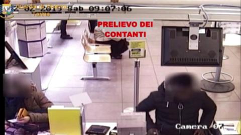 Italy's finance police released footage of cash being withdrawn at a bank by the suspects