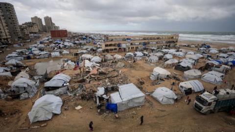 Tents used by displaced people on a beach during a windy winter day in Gaza City, northern Gaza (13 January 2026)