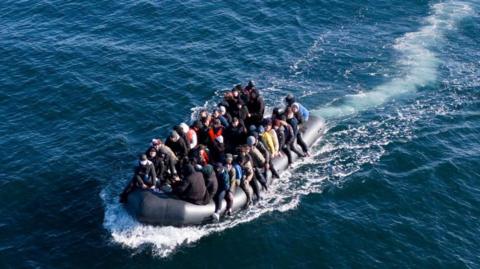 Migrants crossing the English Channel on a small boat