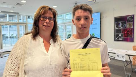 Kenzie and his mother with his pass grades at Northfleet Technology College in Kent