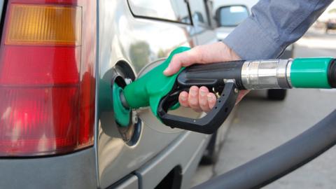 Man putting fuel in car