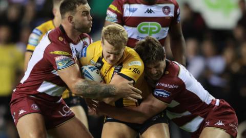 Will Tate (centre) in action for Castleford Tigers