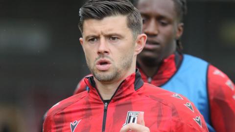 Close up of Aaron Cresswell warming up before a match in his red Stoke City track top.