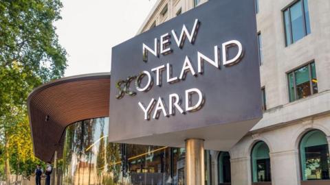 The triangular New Scotland Yard sign in front of offices in London