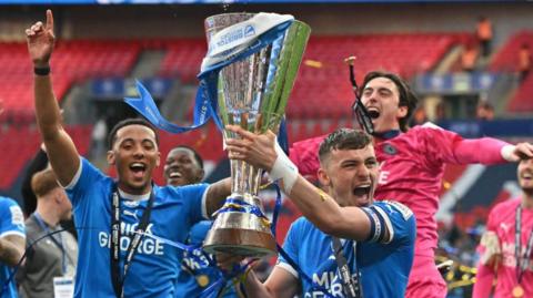 Peterborough United players with the EFL trophy at Wembley last season