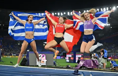 Molly Caudery (right) celebrates pole vault bronze with her fellow medallists