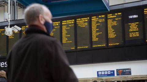 Man looking at departure board in London Euston