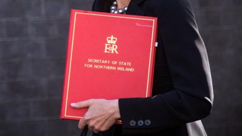 Teresa Villiers holding Secretary of State folder