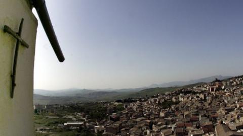 A crucifix towers over Corleone, Italy, the ancestral home and surname of the title characters in The Godfather novel and films