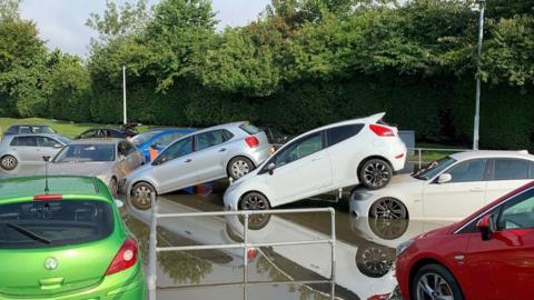 cars piled up after flooding