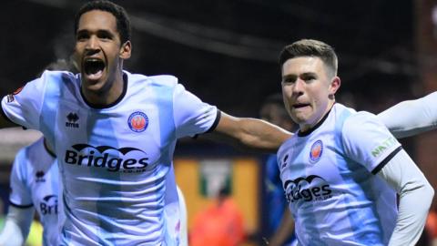 Aldershot players celebrate their goal against Stockport