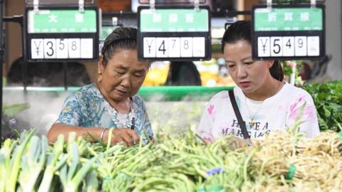 Citizens buy agricultural and sideline products in the supermarket poverty alleviation sales zone. Guiyang City, Guizhou Province, China, September 9, 2020.-