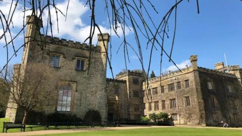 External view of Burnley's Towneley Hall, a large square stone building with crenelations